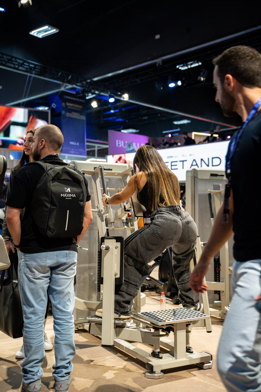 Athlete using the GluteLeader Standing Hip Abductor GL-1005 at a fitness exhibition