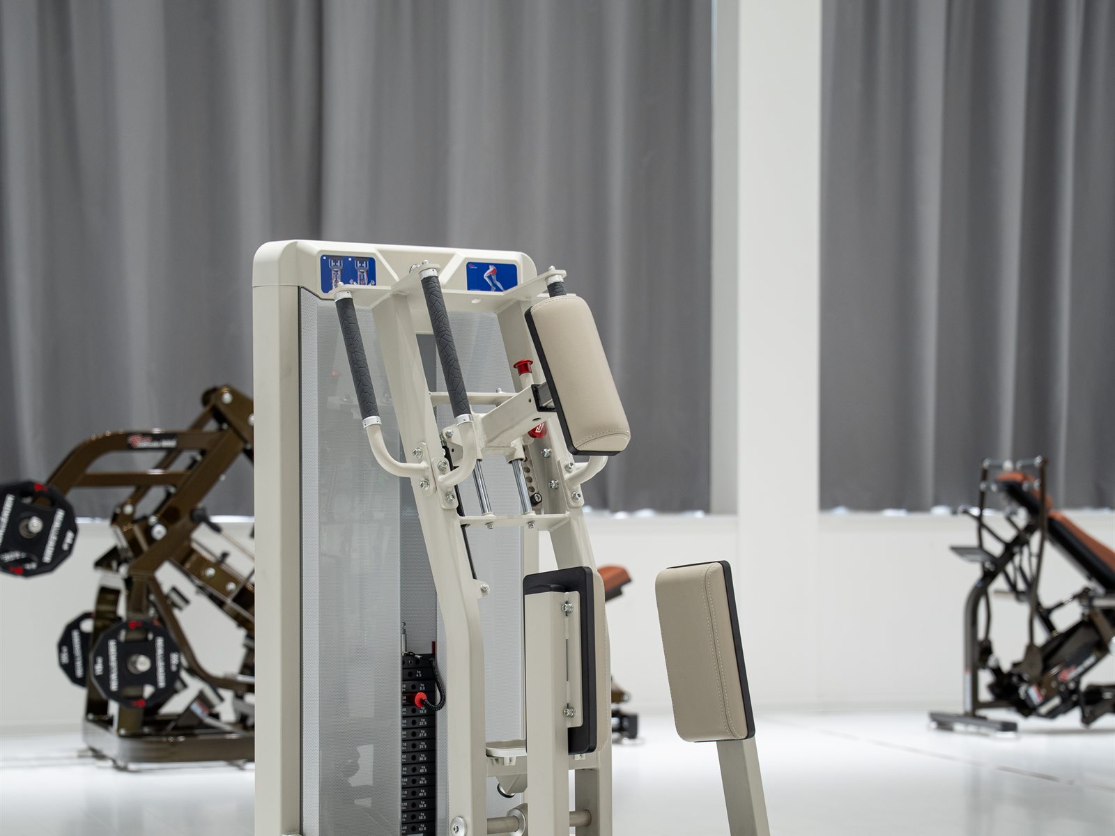 GluteLeader abductor machine in a bright commercial showroom