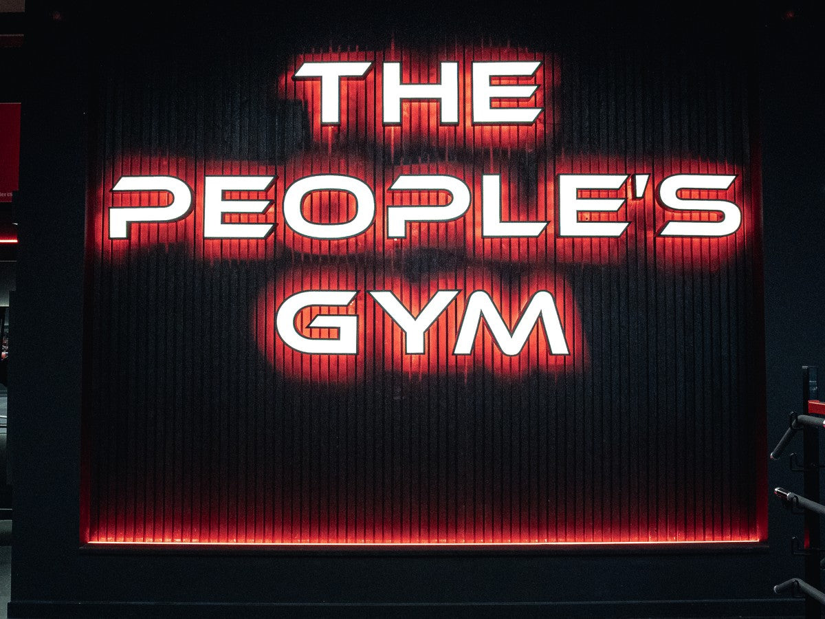 The People's Gym illuminated sign on black slatted wall panelling with red perimeter lighting
